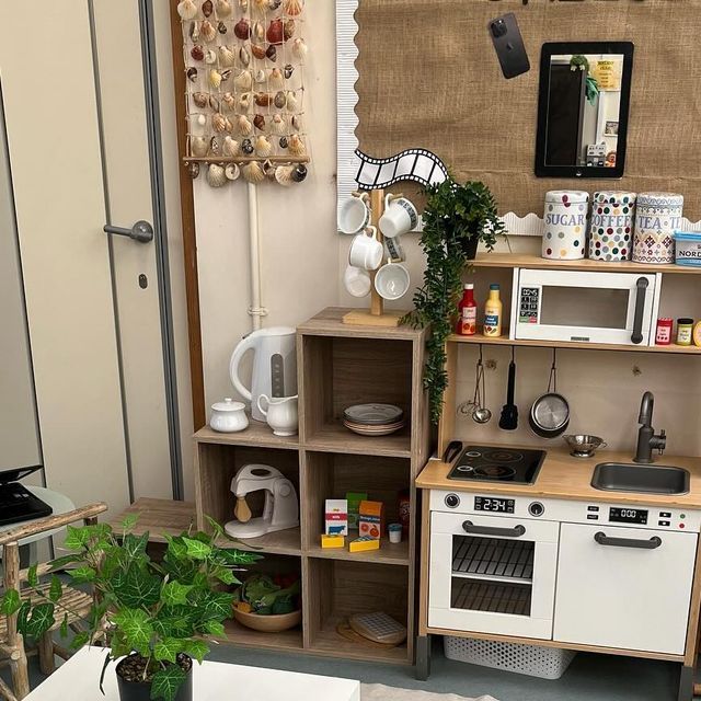 a small kitchen with white appliances and wooden shelves