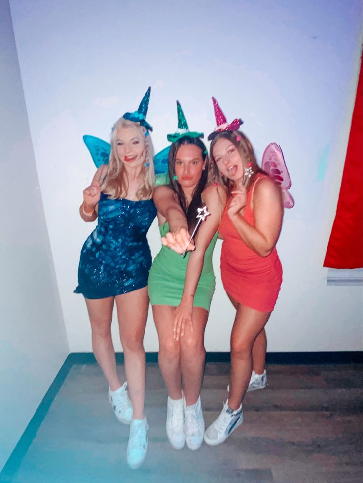 three women dressed up in costumes posing for the camera