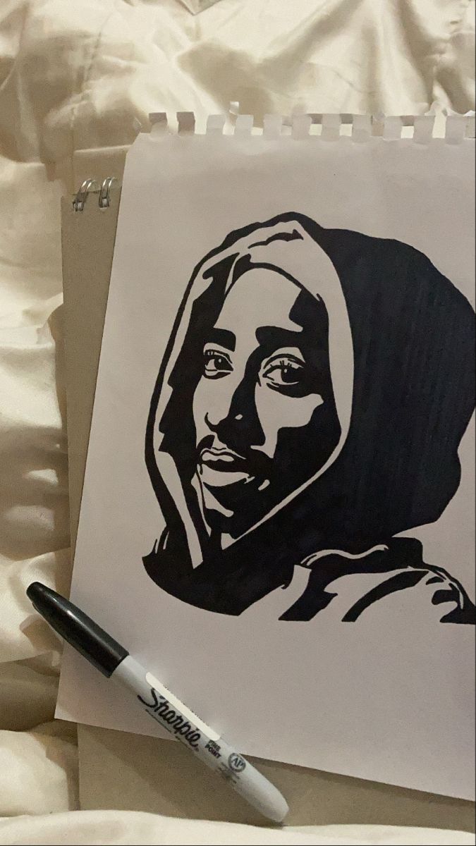 a black and white drawing of a woman's face on a piece of paper