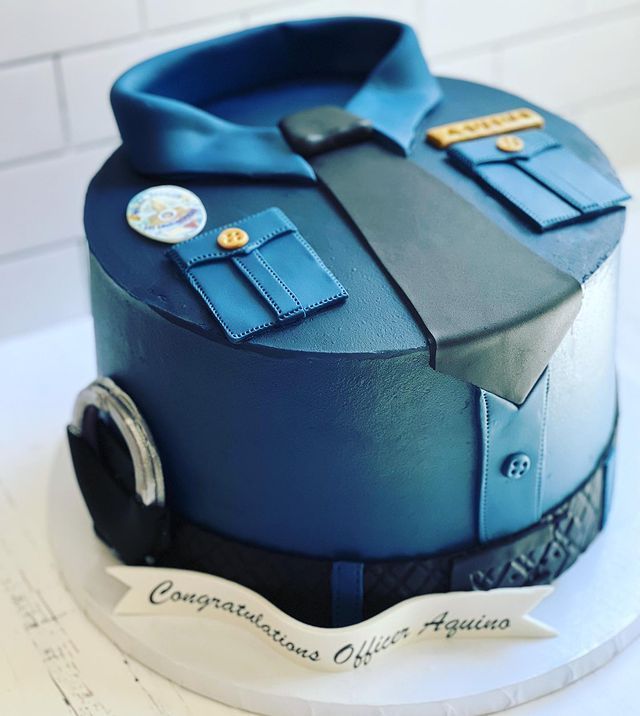 a cake that is shaped like an officer's uniform