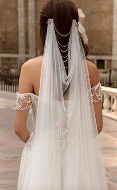 the back of a woman wearing a wedding veil