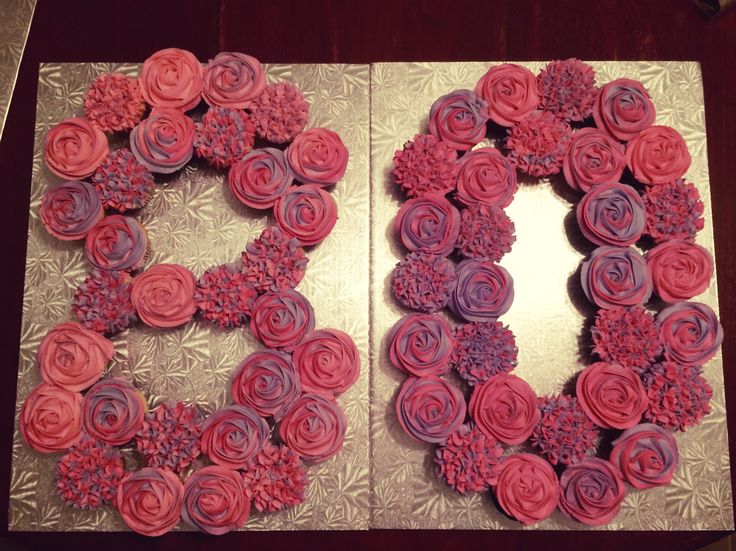 two cupcakes in the shape of flowers on a table