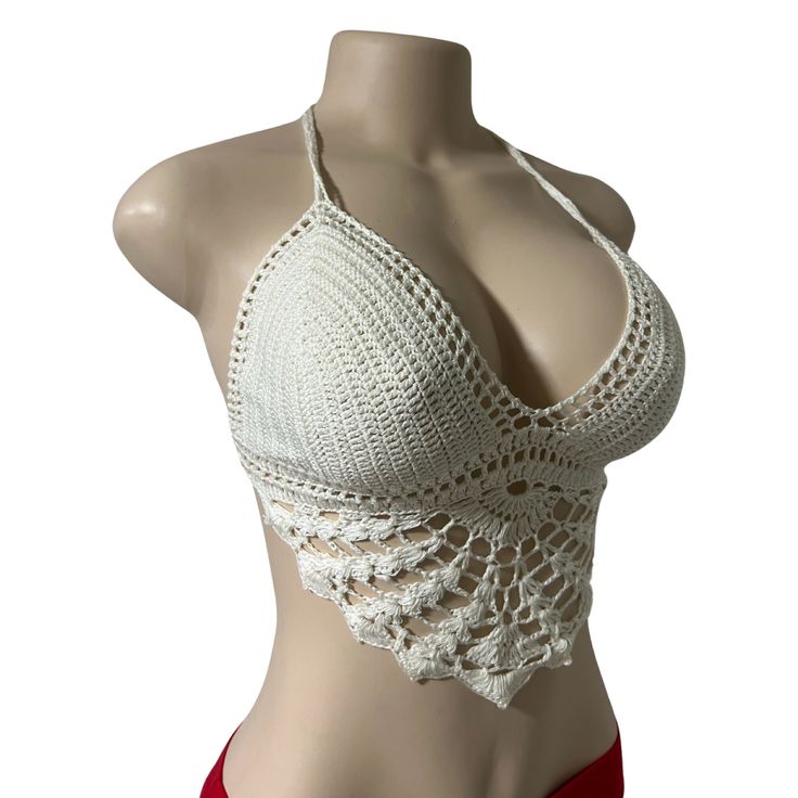 a female mannequin wearing a white top with crochet