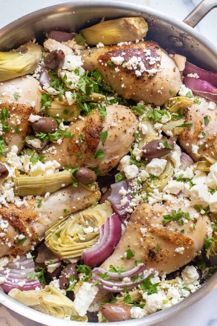 chicken and artichokes in a pan with feta cheese