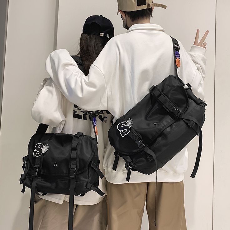 Materials: Nylon Size: 37cm X 18cm X 24cm(Large) 31cm X 16cm X 22cm(Small) Weight: 0.45Kg(Large) 0.39(Small) Casual Backpack With Top Carry Handle, Trendy Nylon Satchel With Large Capacity, Large Capacity Rectangular Satchel For Streetwear, Trendy Large Capacity Nylon Satchel, Large Capacity Nylon Satchel, Casual Large Capacity Crossbody Travel Bag, Casual Black Backpack With Top Carry Handle, Streetwear Rectangular Shoulder Bag With Adjustable Strap, Casual Satchel Travel Bag For School