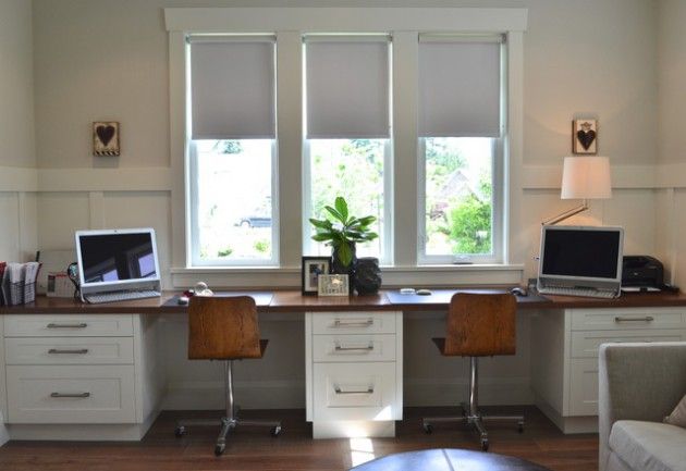 a home office with two computers on the desk