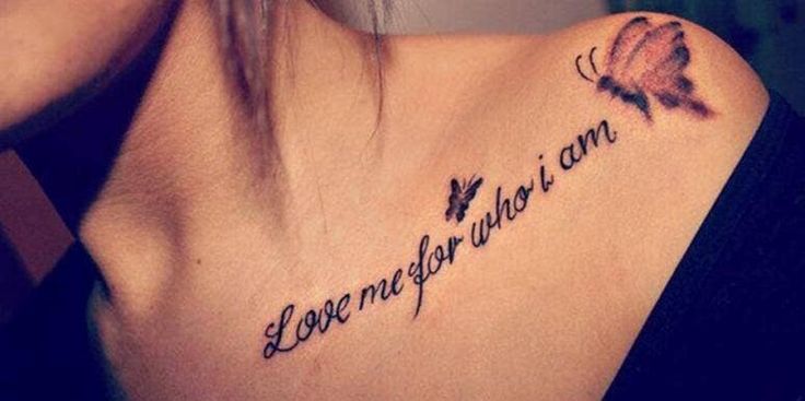 a woman's chest with the words love is all you need written on it