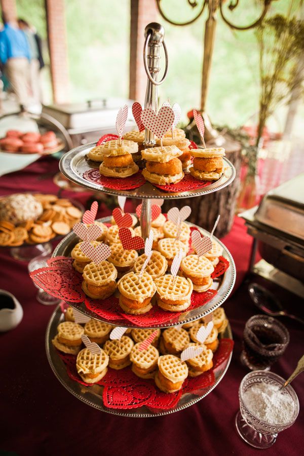 three tiered trays filled with waffles and other treats on a table