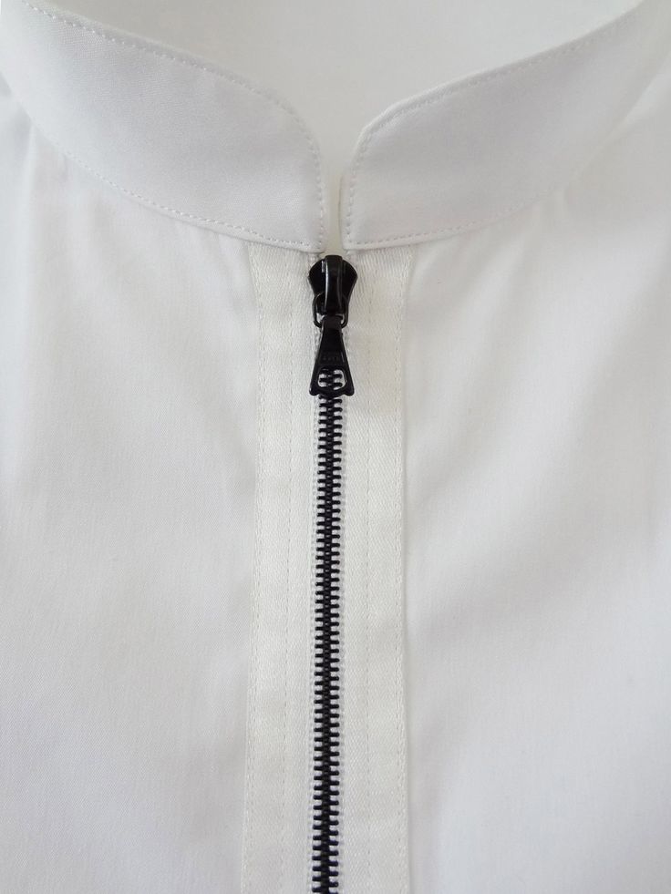 an open zipper on a white shirt