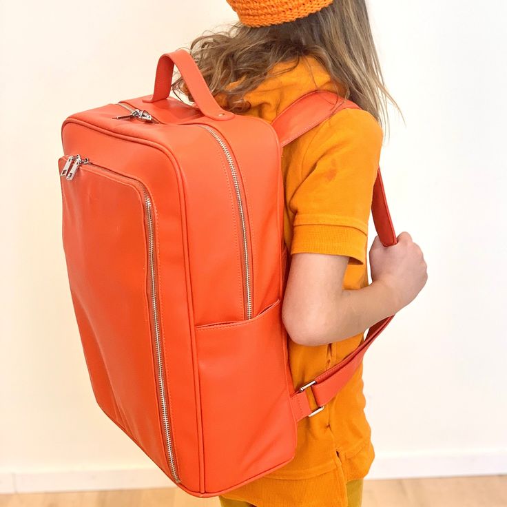 The orange backpack, my friends. It's here and it allows you to own that true orange backpack that you've been hunting! You found it! Monochrome backpacks are here to enhance your coolness (not ours!). They're for you. We're working on our own coolness...you work on yours by enjoying the vegan leather love of our orange backpack. Orange you glad? Vegan Leather. 14 x 17 x 7 Functional Orange Backpack For Travel, Functional Orange Travel Backpack, Orange Travel Backpack With Zipper Closure, Functional Orange Backpack For School, Orange Backpack For Everyday Use And Back To School, Orange Travel Bag For Back To School, Orange Rectangular Travel Backpack, Rectangular Orange Backpack For School, Orange Standard Backpack For School