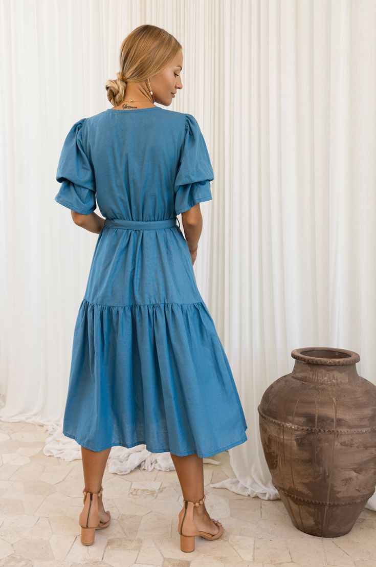 The Peony Dress is a midi-length style that will transition seamlessly from season to season. This divine beauty is crafted from hand-loomed soft linen and designed with a V-neckline, an a-line shape, and gathered puff sleeves that fuse to form this flattering dress. Featuring a fully elasticated waist it comes with a matching linen belt that gives a flattering shape to the silhouette. Complete the look with our stunning Candy heels for the romantic evening or Blossom sandals for a busy day in t Cotton Midi Dress With Gathered Sleeves For Garden Party, Garden Party V-neck Midi Dress With Gathered Sleeves, Bohemian Midi Dress With Gathered Sleeves For Brunch, Chic Linen Midi Dress With Gathered Sleeves, Bohemian Linen V-neck Midi Dress, Bohemian Midi Dress With Gathered Sleeves, Linen V-neck Midi Dress For Brunch, Bohemian Knee-length Midi Dress With Gathered Sleeves, Linen V-neck Midi Dress With Ruffles