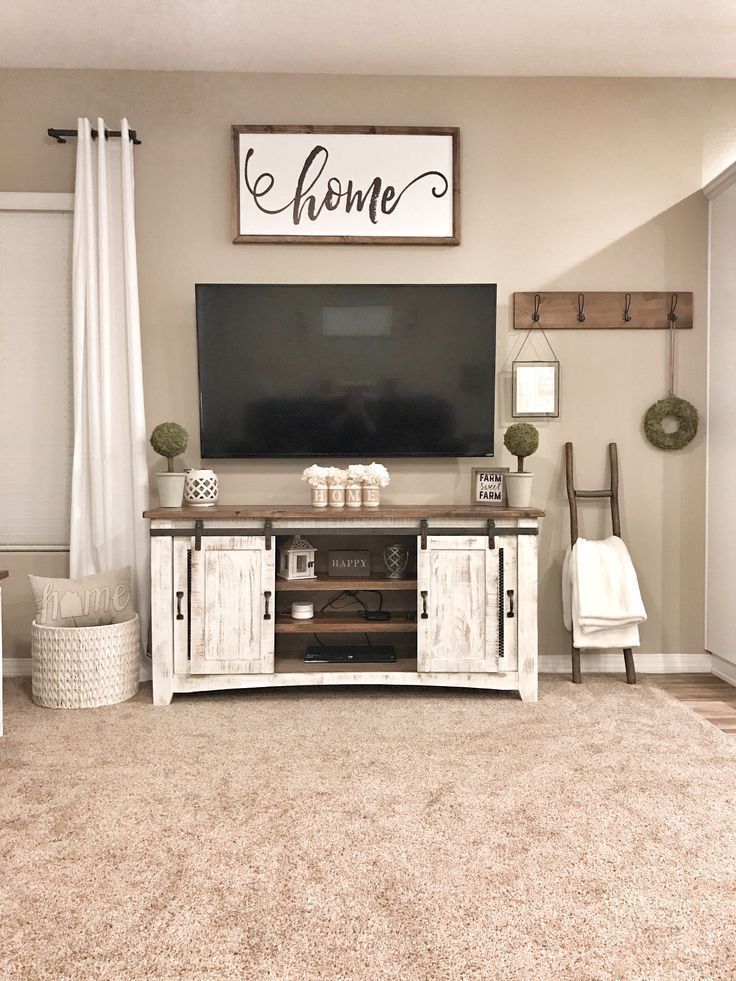 a living room filled with furniture and a flat screen tv on top of a wooden stand