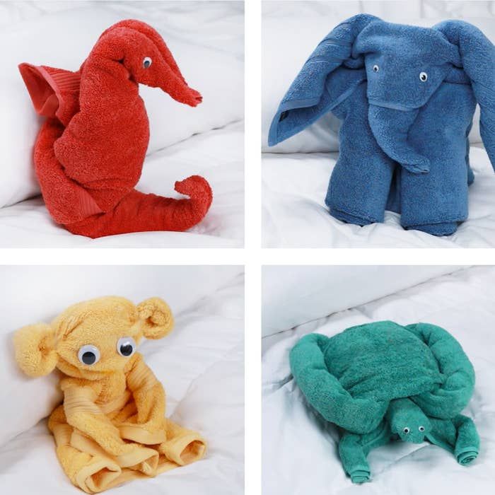 four different colored stuffed animals sitting on a bed