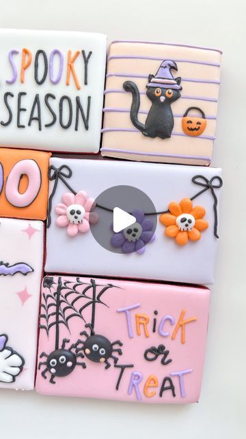 decorated cookies are arranged in the shape of halloween themed candy bars with words on them