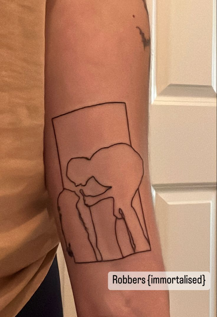 a person with a tattoo on their arm that has an image of a cow and calf