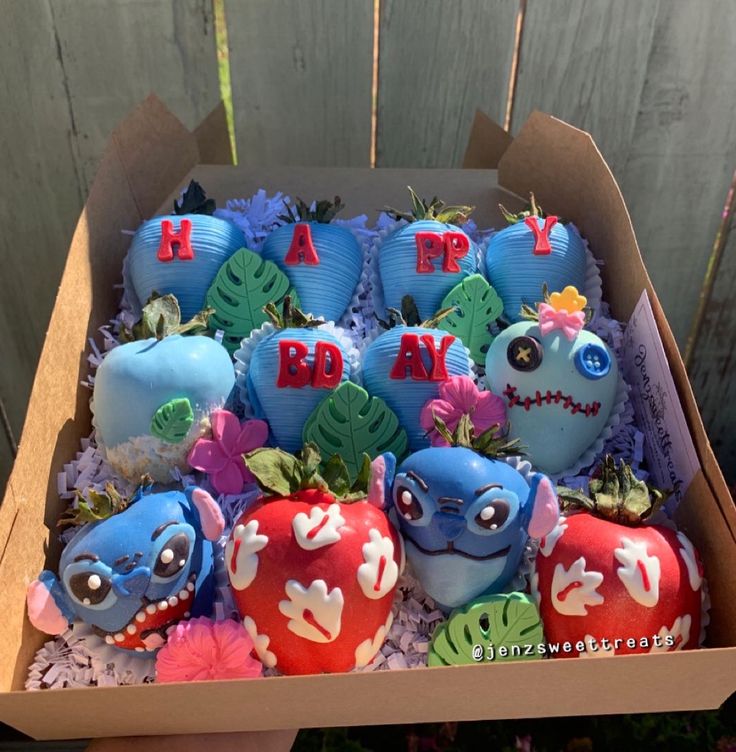 a box filled with blue and red cake covered in frosting