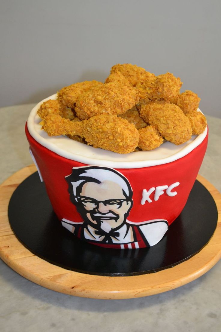 a bowl filled with fried food sitting on top of a wooden plate