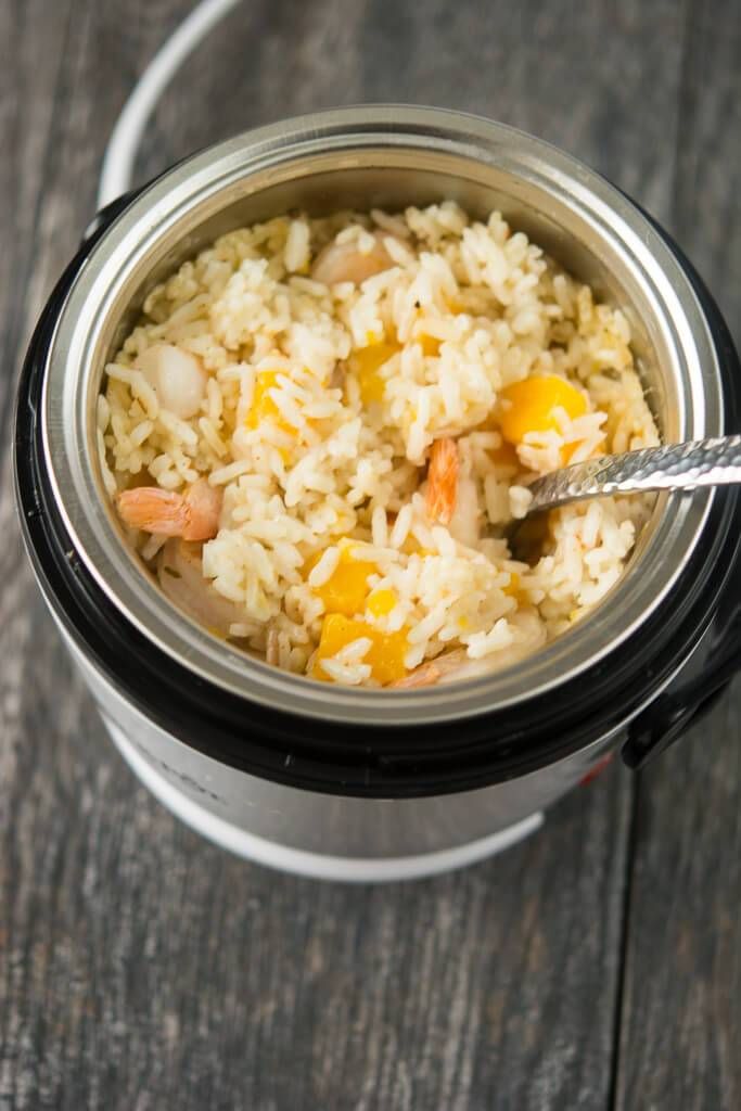 a close up of a bowl of rice and carrots