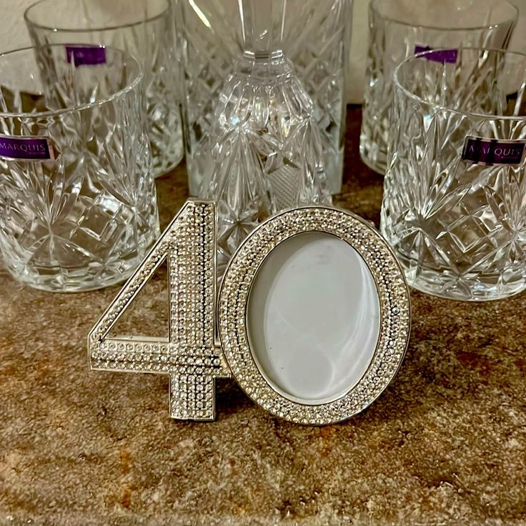 the number forty four sits next to crystal glasses