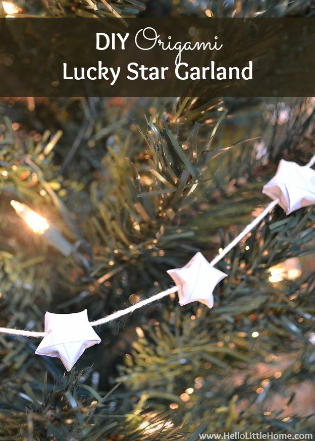 an origami lucky star garland hanging on a christmas tree with text overlay