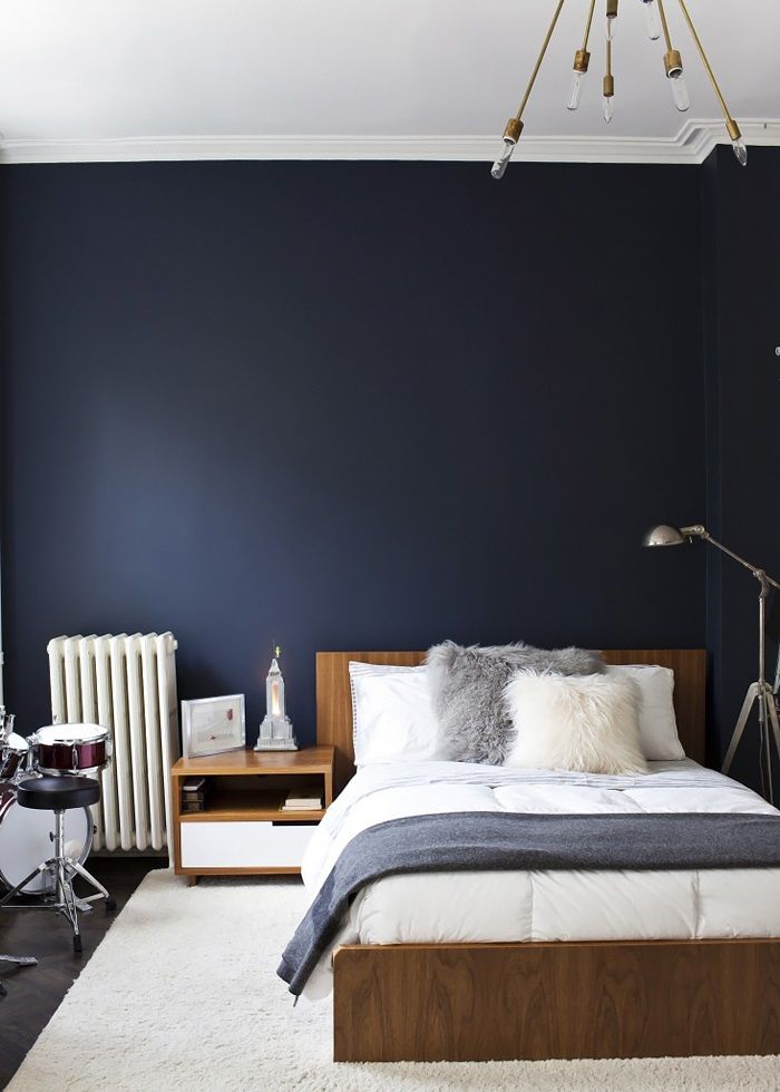 a bedroom with blue walls and white carpet