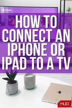 an iphone or ipad sitting on top of a table next to a potted plant