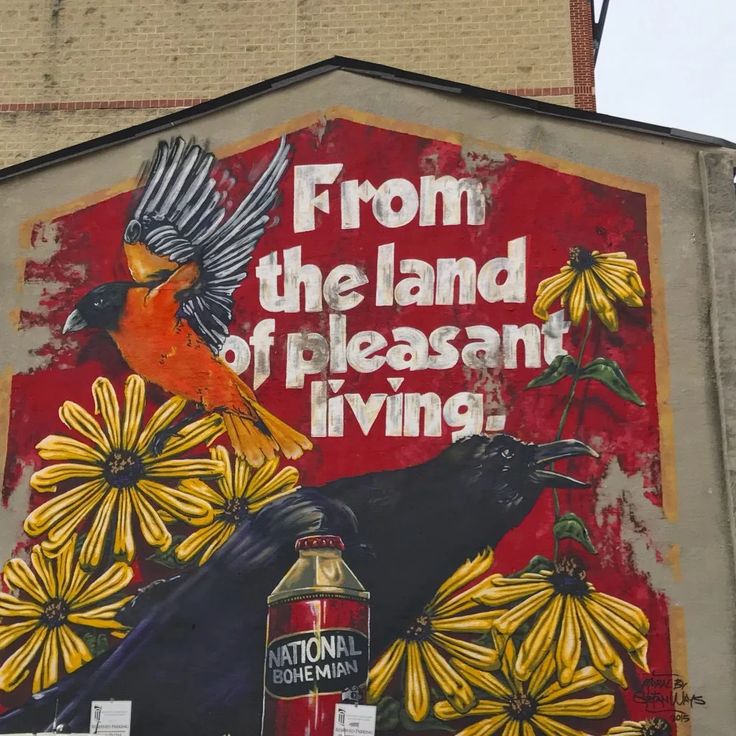 a mural on the side of a building with birds and flowers painted all over it