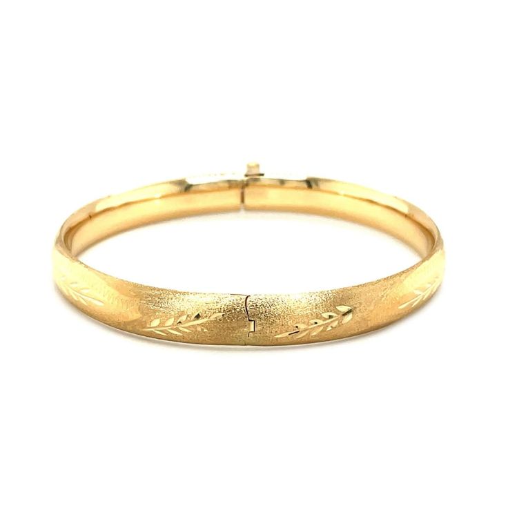 A classic floral carved high polish bangle crafted in 14k yellow gold with a hidden clasp. Bangle Information Width 0.31 inches Clasp Type Hidden Clasp Approximate Weight 9.5 gram(s) - 10.3 gram(s) Available Sizes 7 - 8" Metal 14K Yellow Gold " Luxury Carved Bangle For Women, Luxury Gold Bangle With Gold Clasp, Luxury Gold Clasp Bangle Jewelry, Luxury Carved Bangle For Formal Occasions, Luxury Yellow Gold Bangle For Festive Occasions, Luxury Hallmarked Gold Bangle, Luxury Gold Hallmarked Bangle, Luxury Hallmarked Yellow Gold Bangle, Video Overlay