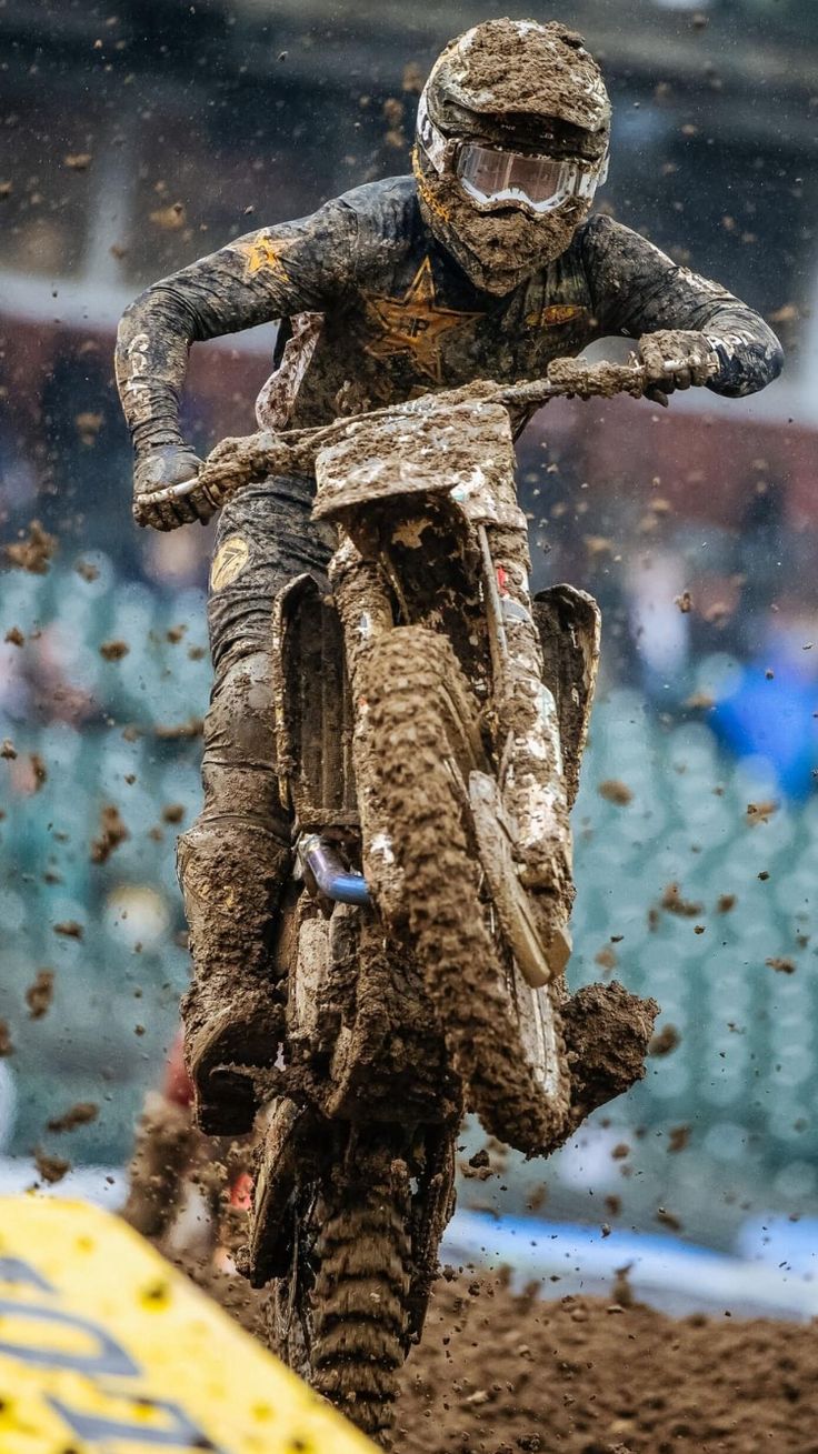 a man riding on the back of a dirt bike