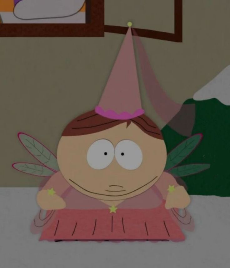 a cartoon character wearing a party hat and sitting in front of a table with food on it