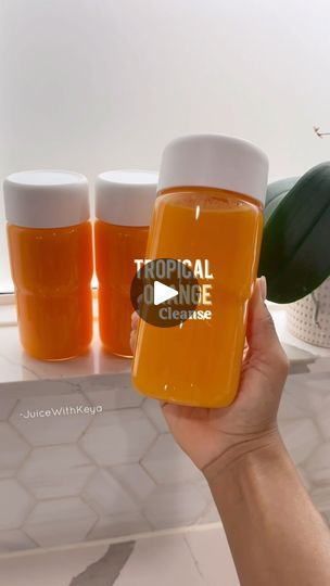 a person holding three glasses with liquid in them and the words tropical on one side