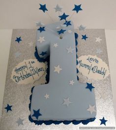 a blue and white birthday cake with stars on the top that says happy 1st birthday