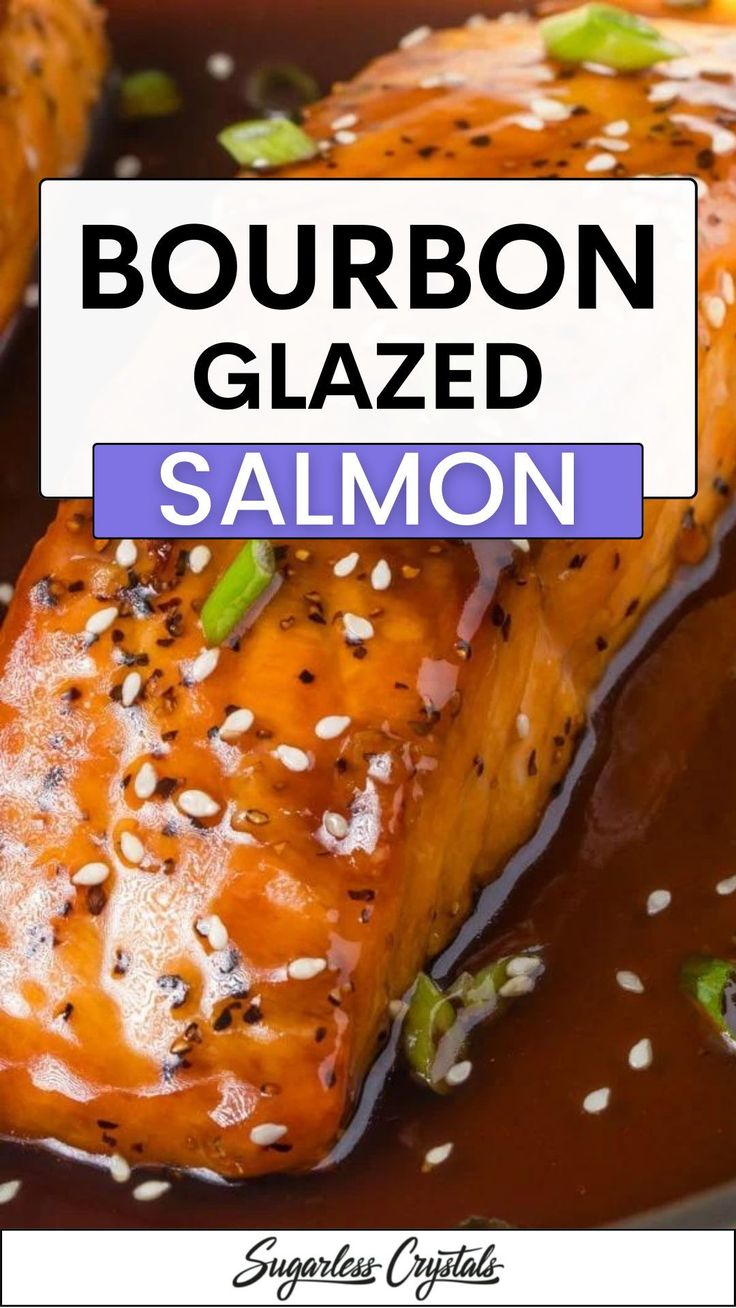 a close up of salmon on a plate with sauce and sesame seeds in the background