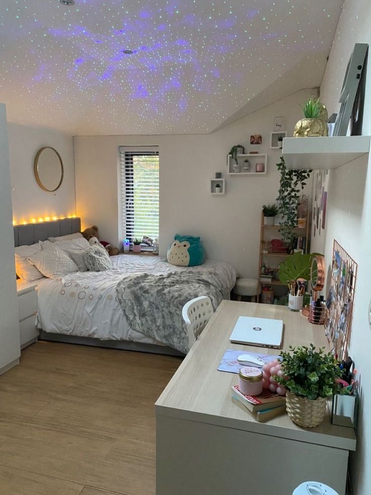 a bed room with a neatly made bed and a desk