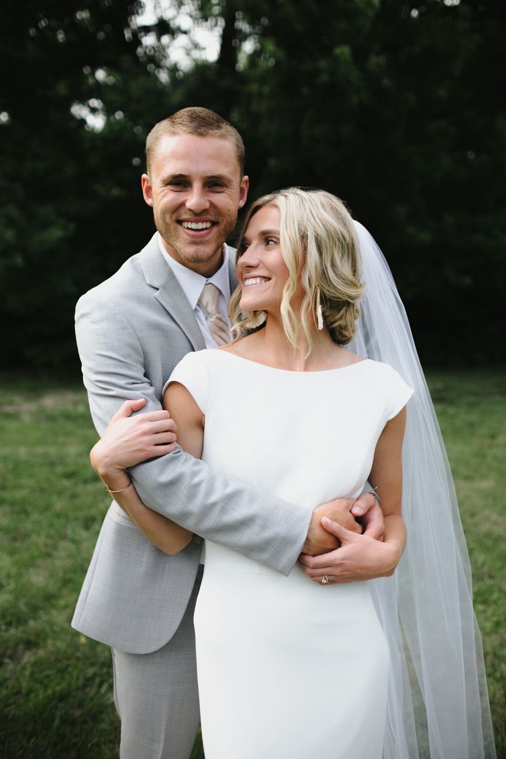 a bride and groom pose for a wedding photo