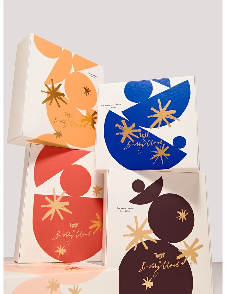 three boxes with different designs on them sitting next to each other in front of a white background