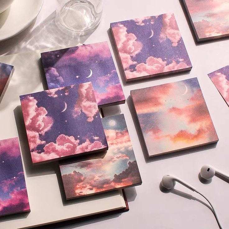 there are many pictures on the table with earphones and headphones next to them