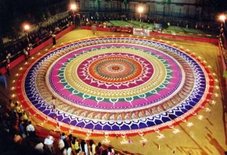 an aerial view of a colorfully lit circle in the middle of a courtyard at night