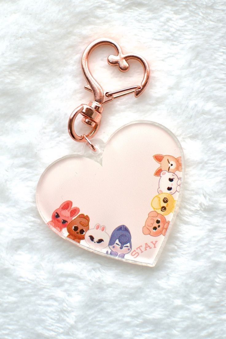 a heart shaped keychain with dogs on it