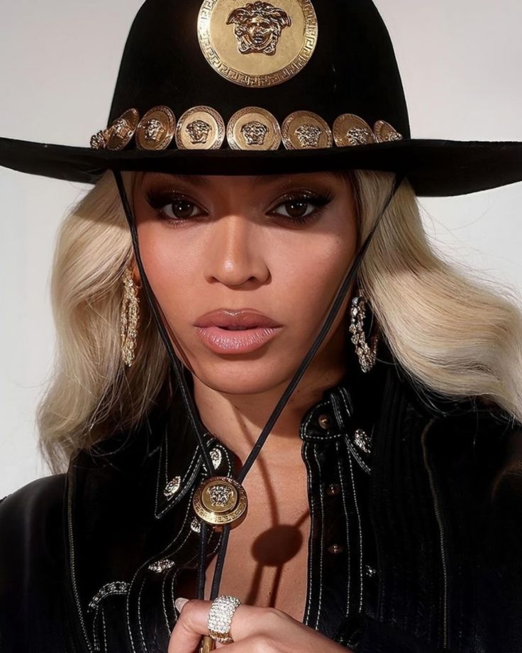 a woman wearing a black hat with gold buttons on the brim and chain around her neck