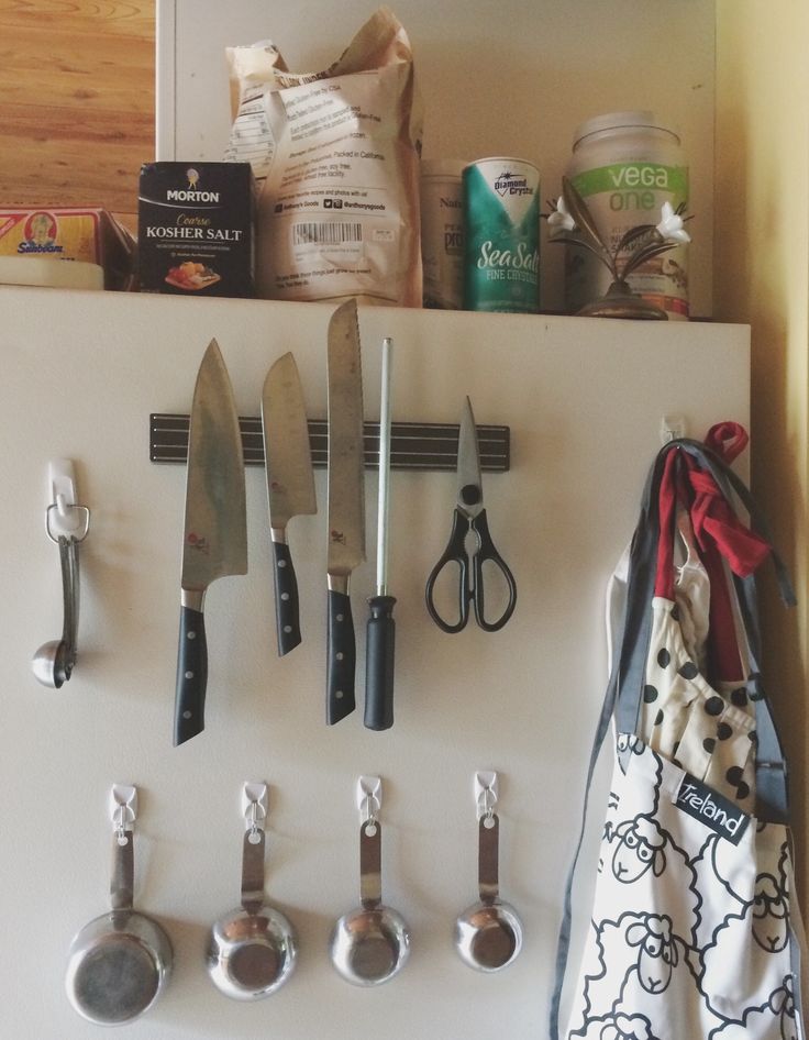 there are many kitchen utensils hanging on the wall