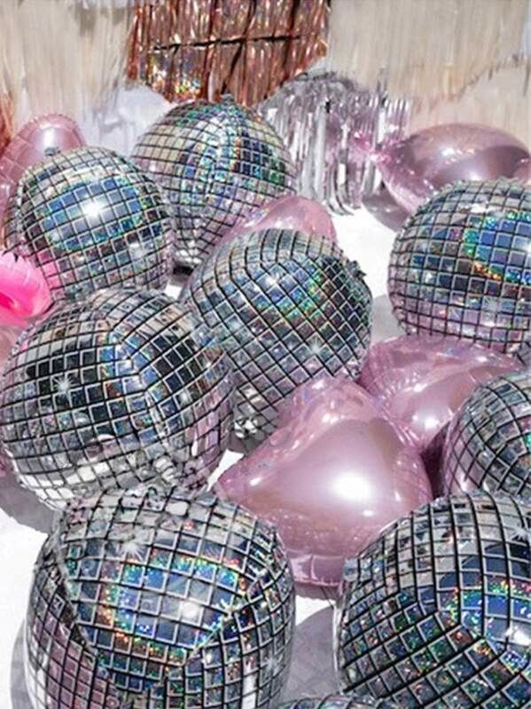 many shiny disco balls with pink ribbons on them