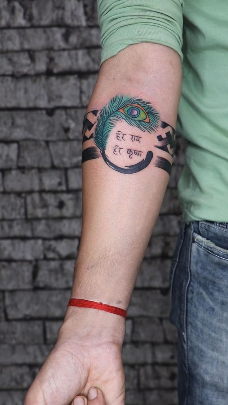 a man with a peacock tattoo on his arm holding the hand of another mans wrist