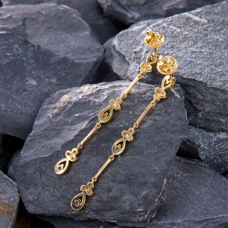 These beautiful textured dangle earrings are bordered with milgrain edging and are each accented with twelve (12) prong/bezel set, round brilliant cut diamonds. The earrings measure 57.0mm in length and 4.6mm in width. The earrings are finished with friction backs for pierced ears. Yellow Gold Linear Dangle Earrings With Diamond Accents, Gold Dangle Diamond Earrings With Bezel Setting, Luxury Gold Linear Earrings With Prong Setting, Luxury Gold Earrings With Bezel Setting, Elegant Gold-plated Hallmarked Diamond Earrings, Gold Bezel-set Dangle Earrings, Gold Dangle Earrings With Bezel Setting, Gold Linear Earrings With Prong Setting For Anniversary, Yellow Gold Bezel-set Dangle Diamond Earrings