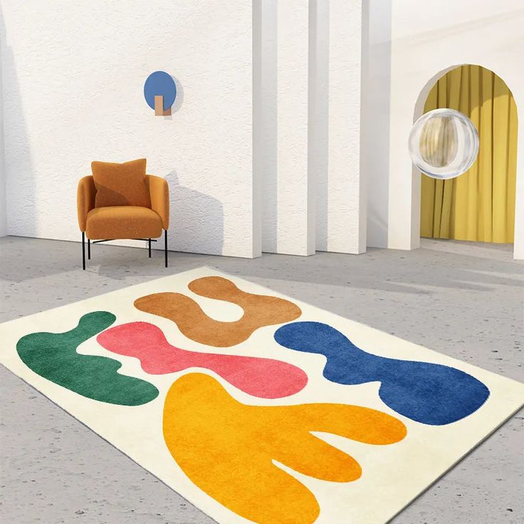 a colorful rug in the middle of a room with two chairs and a chair next to it