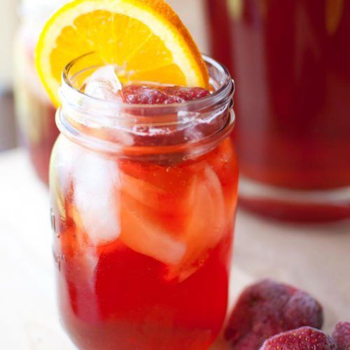 a mason jar filled with strawberry and orange juice