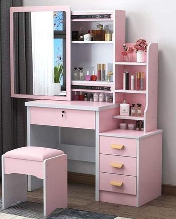 a pink desk with a mirror and stool