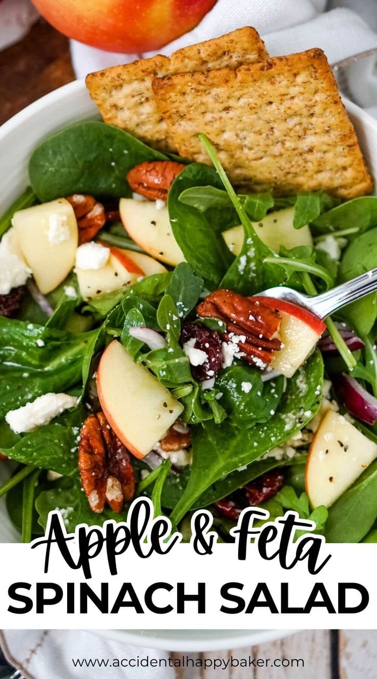 an apple and feta spinach salad in a white bowl