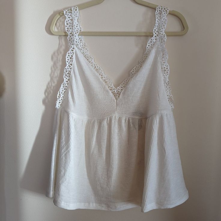 New With Tags, Beautiful Camisole Style In Soft White. Has V-Neck With Seaming Under The Bust And Flowy. Also Has Deep V In Back. Has Eyelet Detail On Shoulders And Bust. So Pretty!! Size L By Umgee Summer V-neck Crop Top With Lace Trim, Feminine V-neck Crop Top For Beach, Spring Lace Trim Tank Top For Brunch, Lace Trim Tank Top For Spring Brunch, Spring Brunch Tank Top With Lace Trim, Spring V-neck Camisole With Lace Trim, Casual V-neck Crop Top With Lace Trim, Spring Cotton V-neck Camisole, Cotton V-neck Camisole For Brunch