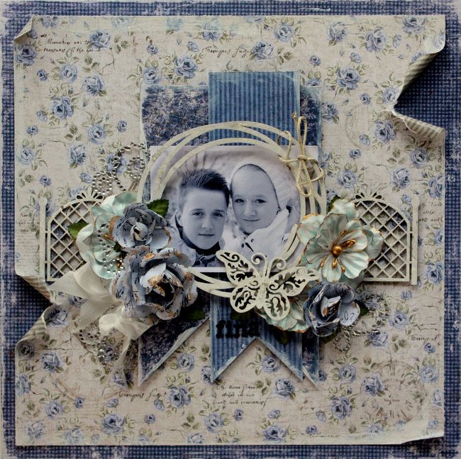 a scrapbook page with an image of two young children in the center and flowers around it